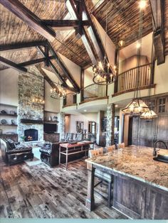 a large kitchen with an island in the middle and lots of wood on the walls