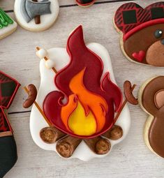 decorated cookies with teddy bears and campfire on white wooden table top, ready to be eaten