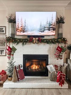 a fireplace decorated for christmas with stockings and presents