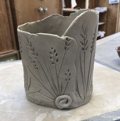 a clay vase sitting on top of a table