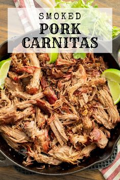 pulled pork carnitas in a skillet with lime wedges