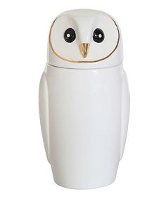 a white ceramic owl with black eyes