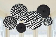 black and white paper fans hanging from the ceiling