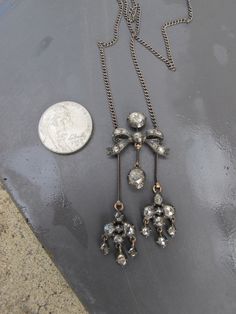 "This is a truly insane and super sparkly antique necklace with rose cut diamonds. The components date to the late Georgian era or early Victorian era but the piece appears to be a marriage of the older components with a later added sterling silver chain. I was originally going to dismantle the necklace to make a pair of dangle earrings, pendant, and a couple rings but never got around to it. The gorgeous rose cut diamonds are collet set into sterling silver with rosy 18k gold backs. The stones Georgian Era, Floral Pendant Necklace, Floral Pendant, Antique Necklace, Rose Cut Diamond, Rose Cut, Sterling Silver Chains, Silver Pendant, Silver Chain