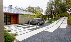 a car parked in front of a house on the side of a road with steps leading up to it