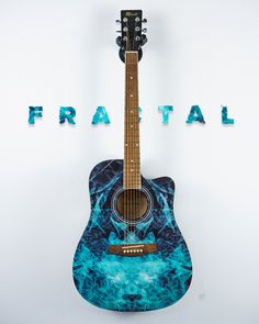 an acoustic guitar sits in front of the words fractal on a white background