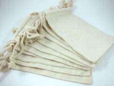 several pieces of cloth with tassels laid out on a white tablecloth background