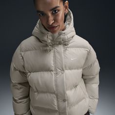 Up your outerwear game in this insulated puffer jacket. A loose fit makes it ideal for layering while the Nike Therma-FIT technology helps manage your body’s natural heat to help keep you warm in cold-weather conditions. A water-repellent finish, bungees at the hem and a hood work together to help shield you from wind and rain. Nike Thermal Jacket, Nike Puffer Jacket, Nike Coat, Thermal Jacket, Women Lifestyle, Weather Conditions, Nike Sportswear, Puffer Jacket, Repellent