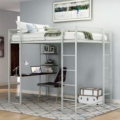 a white loft bed sitting next to a desk with a laptop on top of it