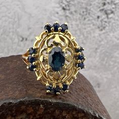 Lovely Deep Blue Sapphires set in a 14k Yellow Gold Shield Ring. US Size 6 Widest point it measures approximately 19 mm. Back of the shank measure approximately 1.8 mm. Stamped 14k Weighs approximately 3.9 grams. Blue Sapphire Ring Stamped 14k, 14k Gold Sapphire Ring Stamped 14k, Blue 14k Gold Cluster Ring, Antique Blue Cluster Ring, Heirloom 14k Gold Blue Sapphire Ring, Heirloom Blue Sapphire Ring In 14k Gold, Gold Sapphire Cluster Ring Hallmarked, 14k Gold Sapphire Cluster Jewelry, Victorian 14k Stamped Blue Rings