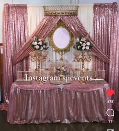 an image of a table set up with pink and gold decorations for a wedding reception