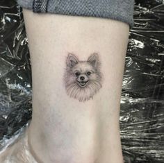 a small dog tattoo on the ankle