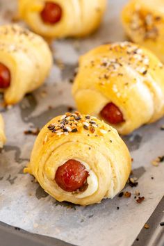 hotdogs wrapped in bread on a baking sheet