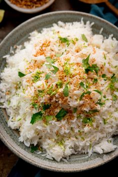 white rice with herbs and seasoning in a bowl