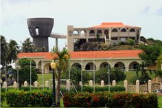 a large building sitting on top of a lush green field