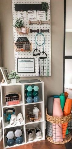 a white shelf filled with lots of different items next to a wall mounted pegboard