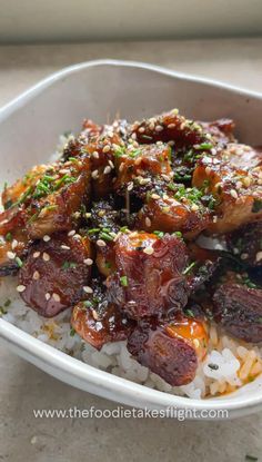 a white bowl filled with rice and meat