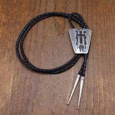 Vintage sterling silver bolo tie. The design is a Navajo spiritual figure called a yei. The bolo is 2" tall x 1 11/16" wide. The cord and tips are 44" long. MJ Sterling is stamped on the back. I have not been able to identify the hallmark. The bolo is in good condition. Thank you for shopping in our store. Please let us know if you have questions. BOLO-1568K k Southwestern Lariat Bolo Tie For Rodeo, Southwestern Style Adjustable Bolo Ties, Silver Lariat Bolo Tie With Adjustable Length, Silver Lariat Bolo Ties With Adjustable Length, Concho Lariat Bolo Ties For Rodeo, Southwestern Silver Bolo Ties For Rodeo, Southwestern Silver Bolo Tie For Rodeo, Southwestern Lariat Bolo Ties For Ranch, Sterling Silver Lariat Bolo Tie