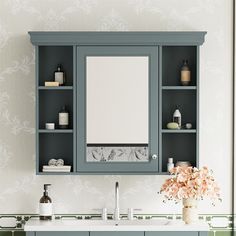 a bathroom vanity with blue cabinets and flowers