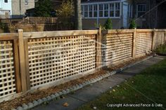 a wooden fence in front of a house