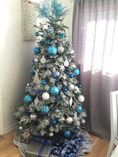 a christmas tree with blue and silver ornaments