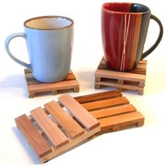 wooden coasters with two mugs on them, one is red and the other is blue