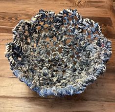 a blue and white bowl sitting on top of a wooden floor