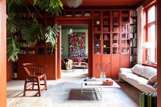 a living room filled with furniture and bookshelves