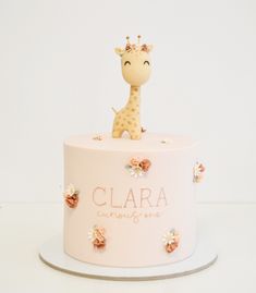 a cake with a giraffe figurine sitting on it's top