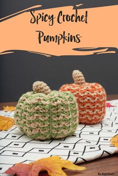 two crocheted pumpkins sitting on top of a table