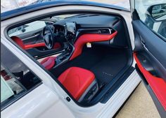 the interior of a car is shown with red and black leather trims on it