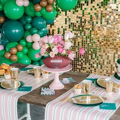 a football themed birthday party with balloons, cake and desserts on a wooden table