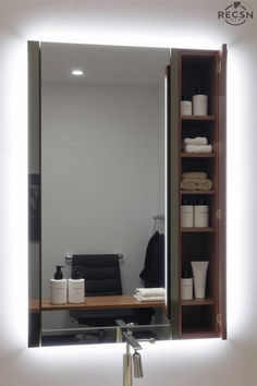 a bathroom mirror with lights on above it and shelves in front of the mirror that are filled with personal items