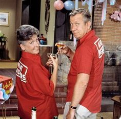 an older man and woman toasting with wine in their hands at a birthday party