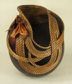 a brown and black vase sitting on top of a table