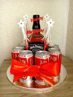 a birthday cake made to look like a bottle of jack daniels with red ribbon and white stars