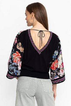 Adorned with bold floral color, the Pullover Blouse offers a distinctly feminine silhouette. Featuring a deep V-neckline at the front and fastened at the back with a delicate tie, this dolman sleeve blouse is finished with a wide elastic waist for a fitted bodice. Pair with a bold, solid-colored skirt and wedge heels for a resort-ready look. Johnny Was Women's The Pullover Blouse in Akki Scarf Print Black, Size Small, Floral Chic V-neck Tops With Floral Embroidery, Multicolor V-neck Top With Floral Embroidery, Chic V-neck Top With Floral Embroidery, Black Long Sleeve Embroidered Top With Floral Print, Black V-neck Top With Floral Embroidery, Black V-neck Tops With Floral Embroidery, Johnny Was Clothing Shirts & Tops, Non-stretch Multicolor Floral Print Blouse, Multicolor Floral Print Scarf, One Size