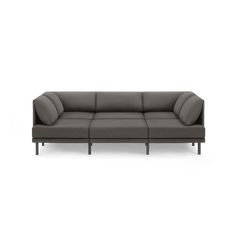 a gray couch with wooden legs on a white background