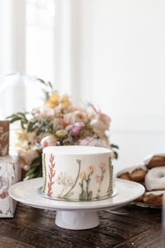 a white cake sitting on top of a wooden table