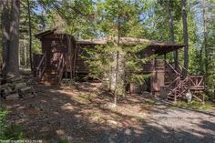 a cabin in the woods surrounded by trees