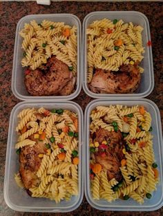 four plastic containers filled with pasta and meat