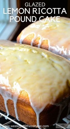 two glazed lemon ricotta pound cakes cooling on a rack with the icing drizzled