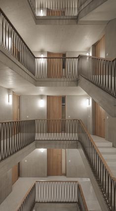 the inside of an apartment building with multiple balconies and wooden railings on each floor