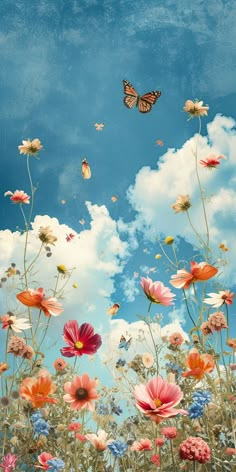 a field full of flowers and butterflies flying in the sky