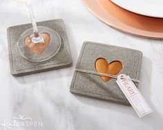 two coasters with hearts on them sitting next to each other