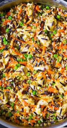 a pot filled with rice and vegetables on top of a stove