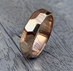 This is a beautiful handcrafted Rock Hammered Mokume Gane ring with a lightly High finish. The ring pictured is approx. 6mm wide. ( The Pattern you can see in picture is how Patina react after couple of days) May be when it arrived it'll look Shinny with low visibility of Pattern. We use the a high quality Mokume Gane which is a combination of copper, brass and silver nickel. The copper and brass will darken over time to give this ring a beautiful contrast with the silver nickel. Our rings are 100% hand-made to order, please allow for time while crafting your ring. Please contact me for current turnaround times. As each piece is unique, the shade, color and may will vary from ring to ring.  It may not always look exactly the same as the photograph. FREE SHIPPING Within US & UK 1 to 2 weeks Mokume Gane Ring, Mokume Gane, 5th Anniversary, Ring Pictures, Copper And Brass, Pretty Wedding, Gift Ring, Wedding Things, Rings Statement