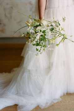 a bride holding a bouquet of flowers in her hand