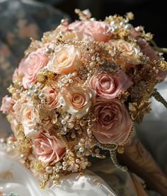 a bridal bouquet with pink roses and gold sequins