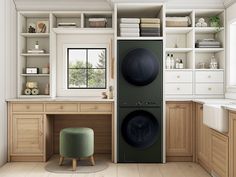 a washer and dryer in a room with wooden cabinets on the wall, next to a green stool